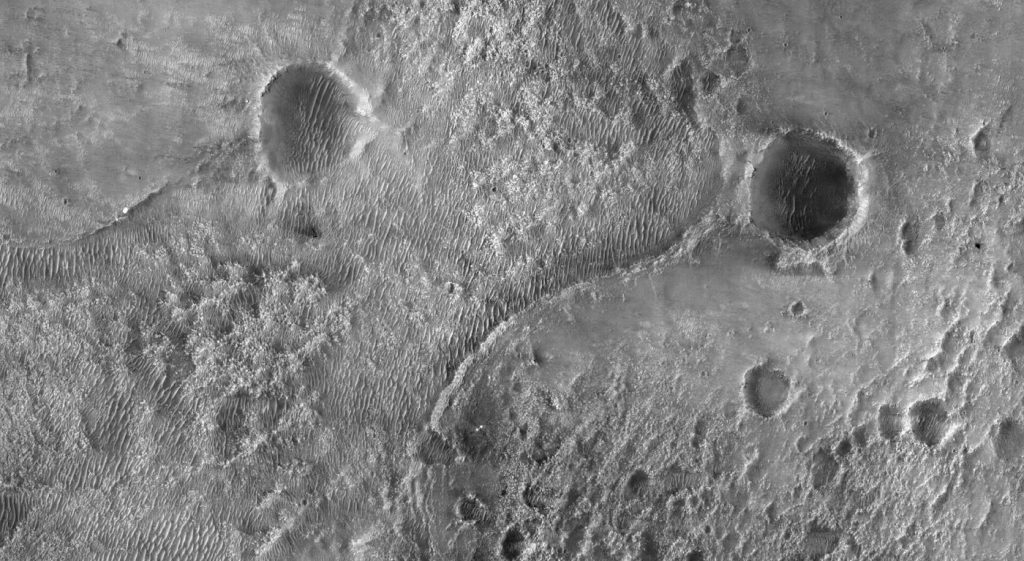 Mars Weather Network Tracks How Dust Shapes the Climate rover tracks across the dusty red surface of Mars